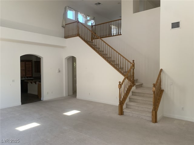 3328 White Bark Pine St, Las Vegas, NV 89129 - stairway with arched walkways, a high ceiling, and carpet flooring