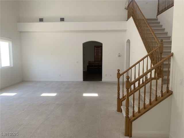 3328 White Bark Pine St, Las Vegas, NV 89129 - carpeted spare room with arched walkways and stairs