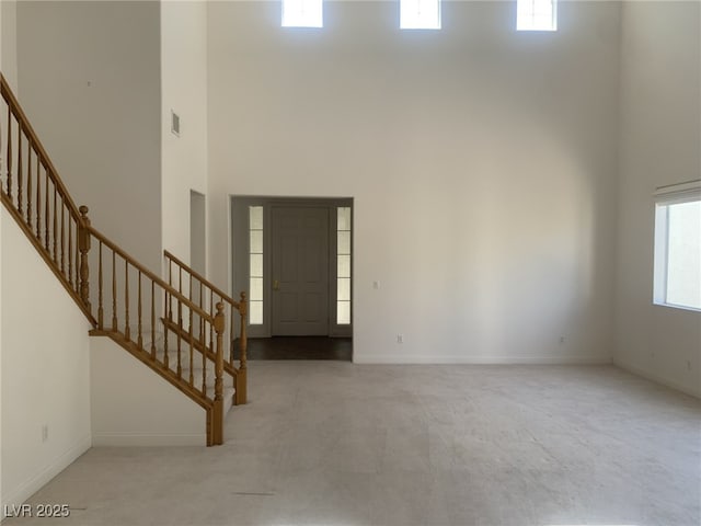 3328 White Bark Pine St, Las Vegas, NV 89129 - carpeted foyer entrance with stairway and a high ceiling