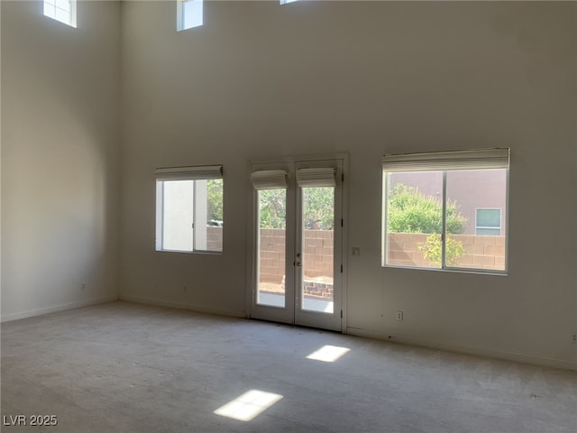 3328 White Bark Pine St, Las Vegas, NV 89129 - carpeted empty room with french doors and a high ceiling