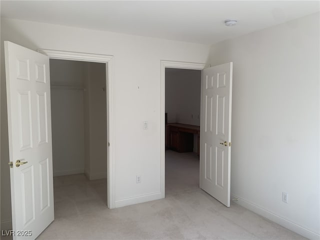 3328 White Bark Pine St, Las Vegas, NV 89129 - unfurnished bedroom with light colored carpet, a spacious closet, and a closet