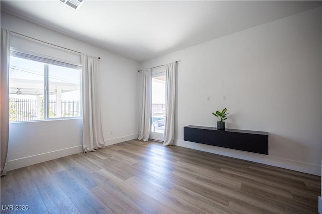 11248 Rebel Dome Ct, Las Vegas, NV 89141 - spare room with healthy amount of natural light and wood finished floors