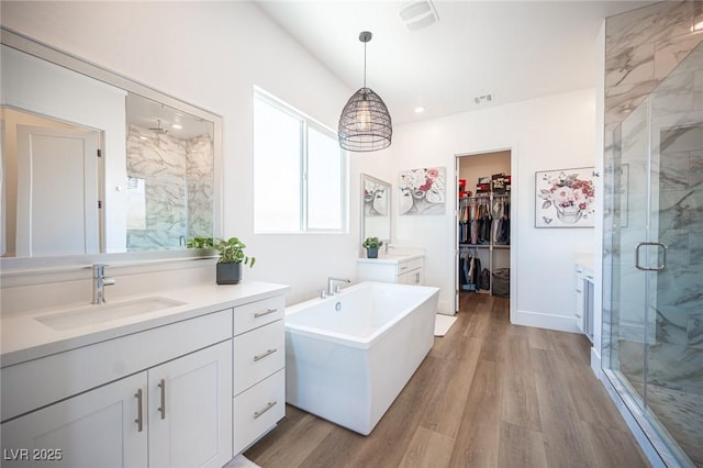 11248 Rebel Dome Ct, Las Vegas, NV 89141 - full bathroom featuring a marble finish shower, vanity, wood finished floors, a freestanding tub, and recessed lighting