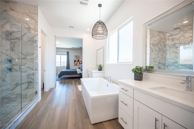 11248 Rebel Dome Ct, Las Vegas, NV 89141 - ensuite bathroom featuring a marble finish shower, wood finished floors, a freestanding tub, vanity, and recessed lighting
