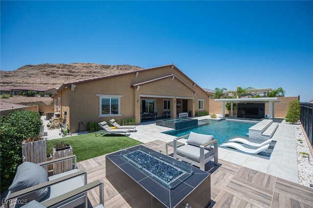 11248 Rebel Dome Ct, Las Vegas, NV 89141 - view of swimming pool with an outdoor fire pit, a patio, a pool with connected hot tub, and a mountain view