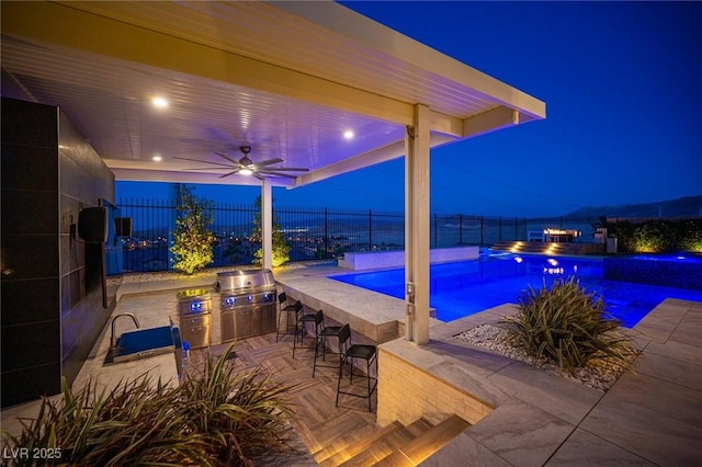 11248 Rebel Dome Ct, Las Vegas, NV 89141 - pool at twilight with exterior bar, a fenced backyard, and a patio area