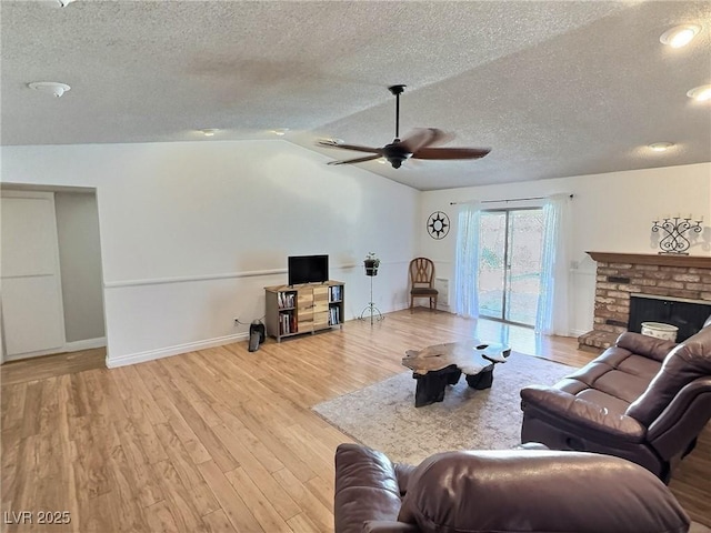 3585 Winner Dr, Las Vegas, NV 89120 - living area with a textured ceiling, ceiling fan, a fireplace, wood finished floors, and vaulted ceiling