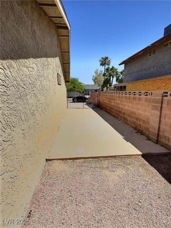 3585 Winner Dr, Las Vegas, NV 89120 - view of side of property with stucco siding and a patio
