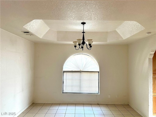 1409 Santa Margarita St Unit B, Las Vegas, NV 89146 - spare room with a textured ceiling, a chandelier, light tile patterned floors, a smoke detector, and a raised ceiling