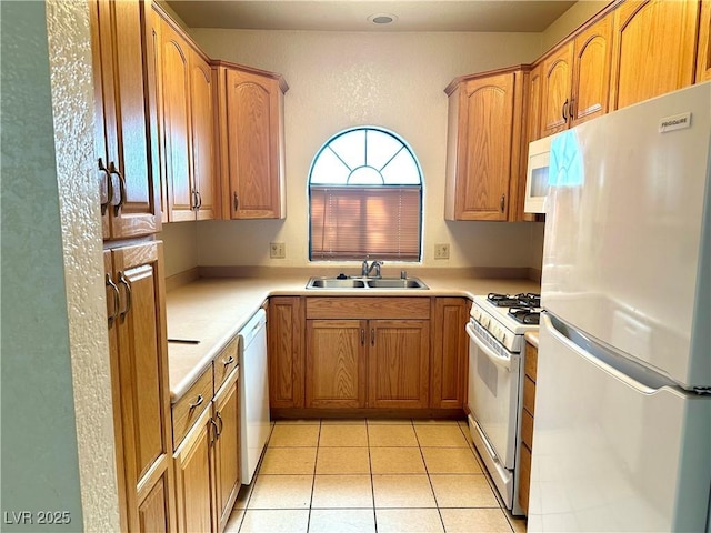 1409 Santa Margarita St Unit B, Las Vegas, NV 89146 - kitchen with white appliances, light tile patterned flooring, light countertops, and brown cabinets