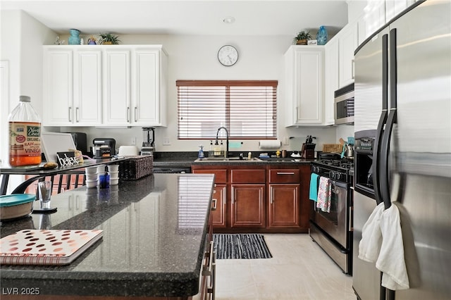 135 Cadrow Castle Ct, Las Vegas, NV 89148 - kitchen with appliances with stainless steel finishes, white cabinetry, dark stone counters, and recessed lighting