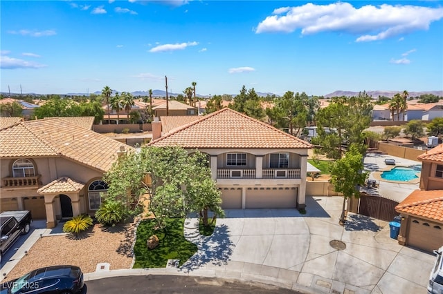1403 Graystone Canyon Ave, Las Vegas, NV 89183 - mediterranean / spanish-style home with a garage, stucco siding, concrete driveway, a tile roof, and a residential view