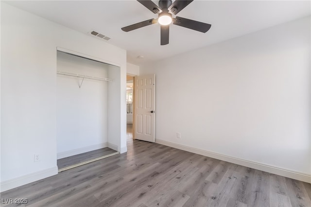 1403 Graystone Canyon Ave, Las Vegas, NV 89183 - unfurnished bedroom featuring wood finished floors, a closet, and a ceiling fan