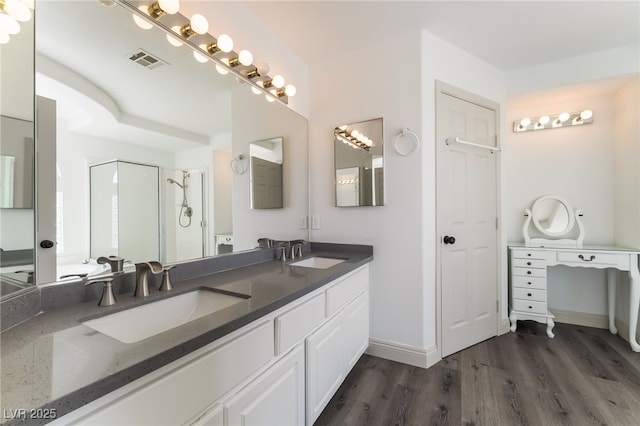 1403 Graystone Canyon Ave, Las Vegas, NV 89183 - bathroom featuring double vanity, wood finished floors, and a shower stall