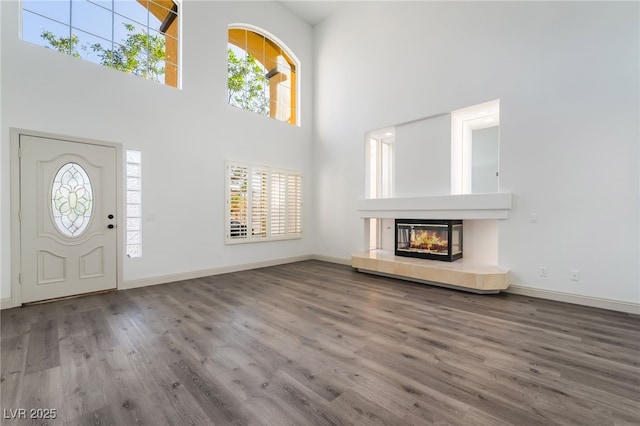 1403 Graystone Canyon Ave, Las Vegas, NV 89183 - entrance foyer with wood finished floors, a high ceiling, and a fireplace