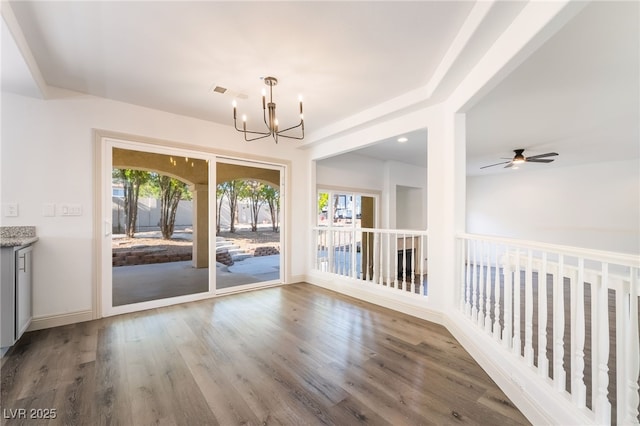 1403 Graystone Canyon Ave, Las Vegas, NV 89183 - unfurnished dining area featuring a chandelier, wood finished floors, and a ceiling fan