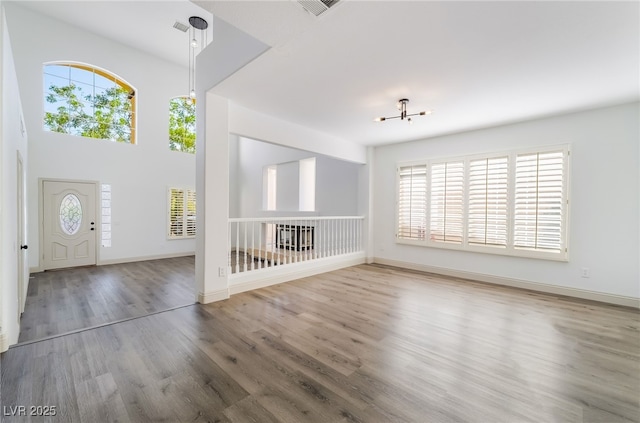 1403 Graystone Canyon Ave, Las Vegas, NV 89183 - entrance foyer featuring plenty of natural light, wood finished floors, and a chandelier