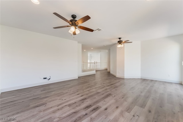 1403 Graystone Canyon Ave, Las Vegas, NV 89183 - unfurnished living room featuring a ceiling fan and light wood finished floors
