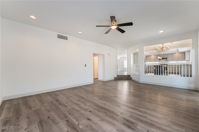 1403 Graystone Canyon Ave, Las Vegas, NV 89183 - unfurnished living room featuring a chandelier, a ceiling fan, wood finished floors, and recessed lighting