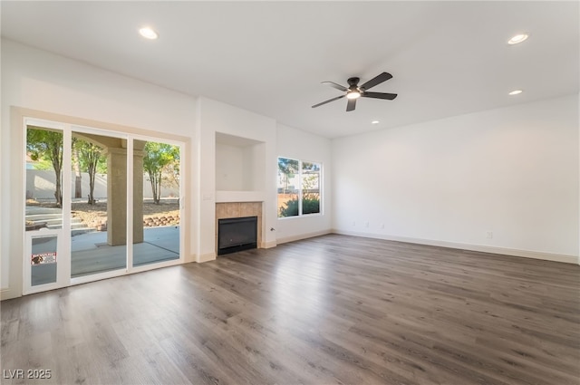 1403 Graystone Canyon Ave, Las Vegas, NV 89183 - unfurnished living room featuring wood finished floors, ceiling fan, a tile fireplace, and recessed lighting
