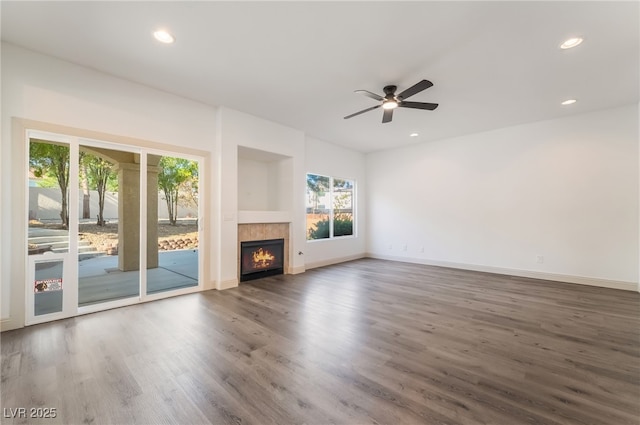 1403 Graystone Canyon Ave, Las Vegas, NV 89183 - unfurnished living room with wood finished floors, ceiling fan, recessed lighting, and a tile fireplace