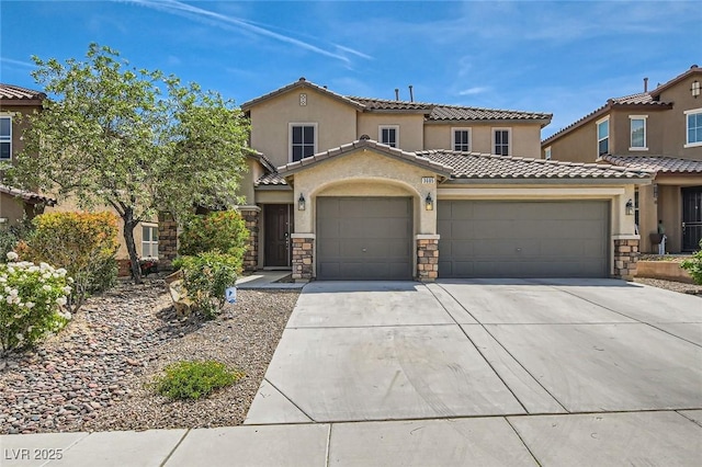 3605 Sapphire Sea Ct, North Las Vegas, NV 89031 - view of front facade with concrete driveway, an attached garage, a tile roof, stucco siding, and stone siding