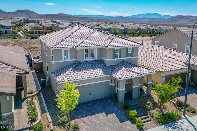 2577 Tolmezzo St, Henderson, NV 89044 - mediterranean / spanish-style home featuring a tiled roof and an attached garage