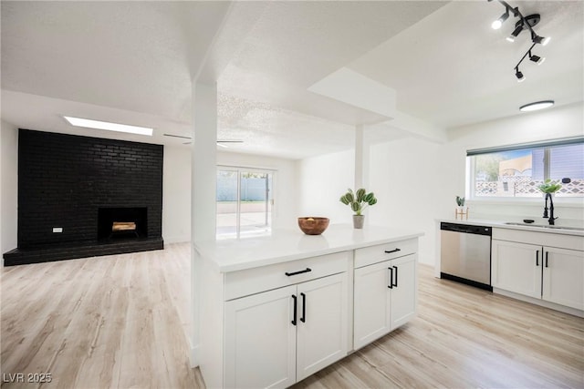 716 Vincent Way, Las Vegas, NV 89145 - kitchen with stainless steel dishwasher, light wood-style flooring, open floor plan, and light countertops