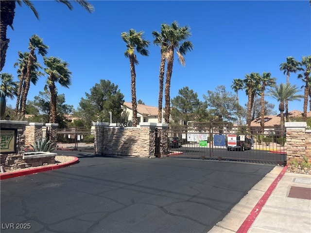 1830 N Buffalo Dr Unit 2021, Las Vegas, NV 89128 - view of asphalt street with a gate, curbs, and a gated entry