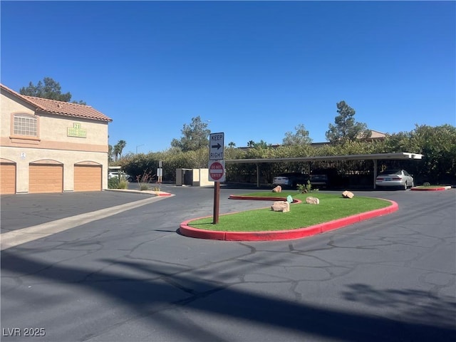 1830 N Buffalo Dr Unit 2021, Las Vegas, NV 89128 - view of asphalt street featuring traffic signs and curbs