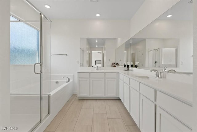 9221 Alden Pointe Ct, Las Vegas, NV 89143 - bathroom with double vanity, a garden tub, healthy amount of natural light, a shower stall, and recessed lighting