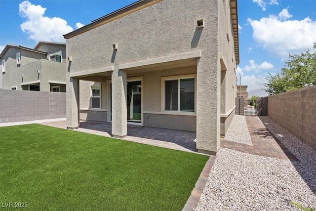 9221 Alden Pointe Ct, Las Vegas, NV 89143 - rear view of property with a fenced backyard, a patio, and stucco siding
