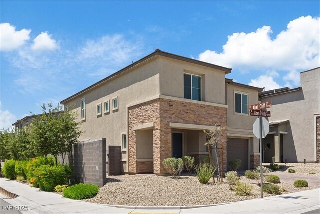 9221 Alden Pointe Ct, Las Vegas, NV 89143 - view of front facade featuring stone siding, stucco siding, and a garage