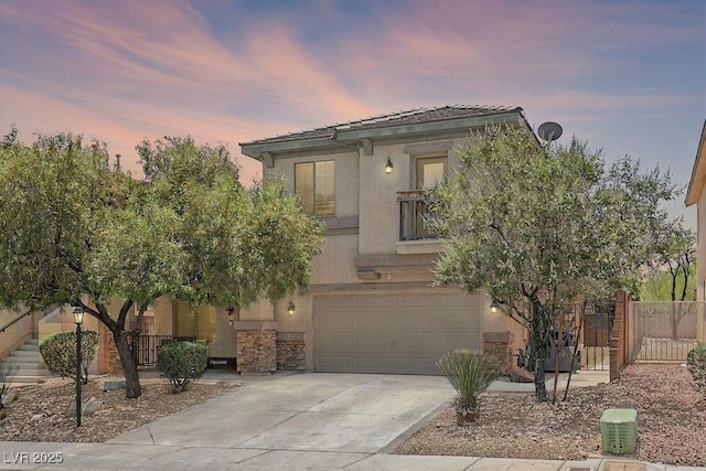 9105 Picket Fence Ave, Las Vegas, NV 89143 - view of front of house with stone siding, concrete driveway, an attached garage, and stucco siding