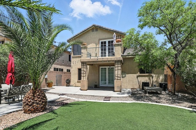 9105 Picket Fence Ave, Las Vegas, NV 89143 - back of property with french doors, a balcony, stucco siding, and a patio area
