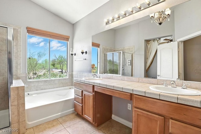 9105 Picket Fence Ave, Las Vegas, NV 89143 - full bath featuring tile patterned floors, double vanity, a shower stall, a garden tub, and lofted ceiling