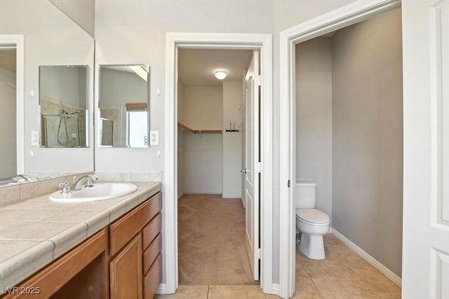 9105 Picket Fence Ave, Las Vegas, NV 89143 - full bath featuring vanity, tile patterned floors, tiled shower, and a spacious closet