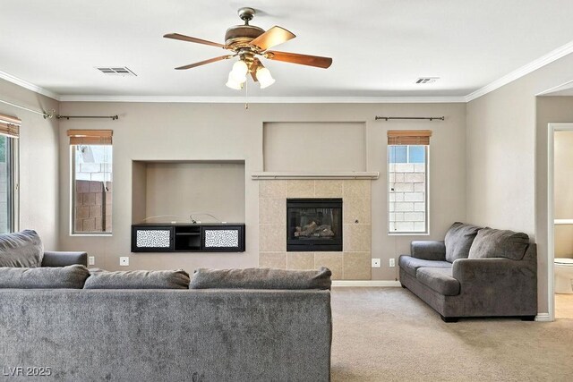 9105 Picket Fence Ave, Las Vegas, NV 89143 - living room featuring a ceiling fan, carpet floors, plenty of natural light, ornamental molding, and a fireplace