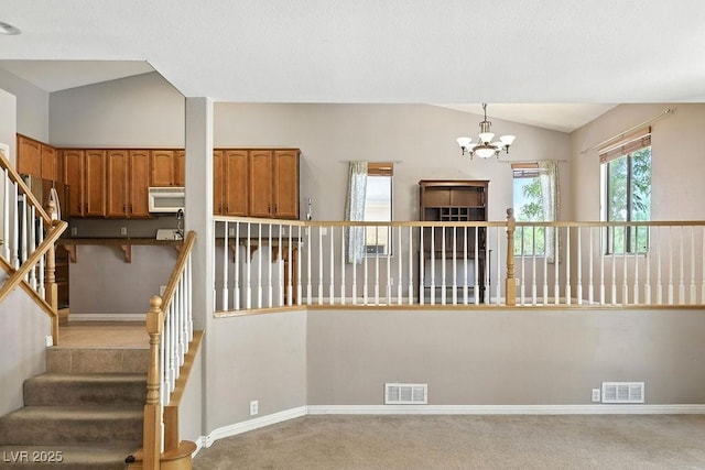 9105 Picket Fence Ave, Las Vegas, NV 89143 - stairs with vaulted ceiling, a chandelier, and carpet floors