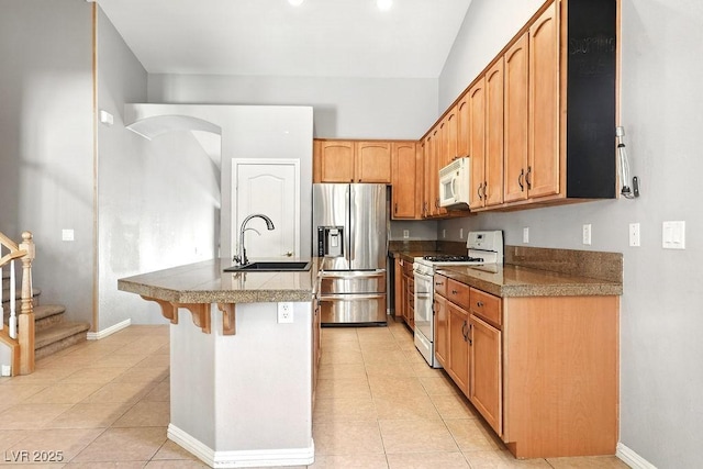 9105 Picket Fence Ave, Las Vegas, NV 89143 - kitchen with white appliances, light tile patterned floors, a center island with sink, and a breakfast bar