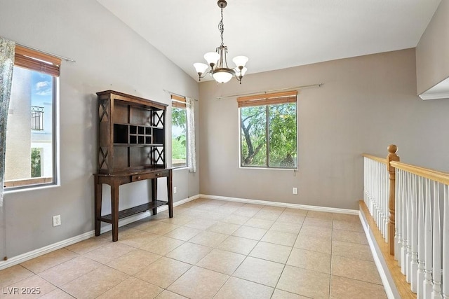 9105 Picket Fence Ave, Las Vegas, NV 89143 - spare room featuring a chandelier, light tile patterned flooring, and vaulted ceiling
