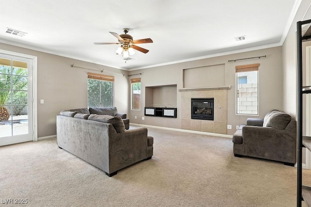 9105 Picket Fence Ave, Las Vegas, NV 89143 - carpeted living room featuring ceiling fan, plenty of natural light, ornamental molding, and a tile fireplace