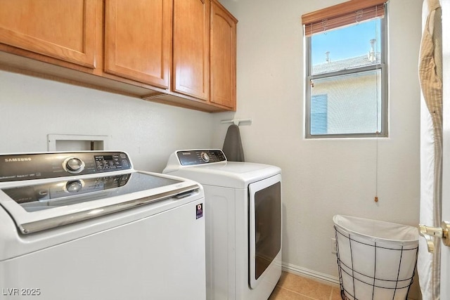9105 Picket Fence Ave, Las Vegas, NV 89143 - laundry area featuring washing machine and clothes dryer, cabinet space, and light tile patterned floors