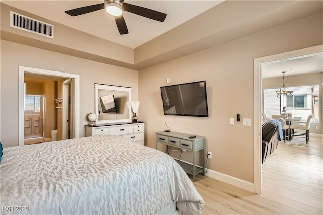 63 E Agate Ave Unit 509, Las Vegas, NV 89123 - bedroom with light wood-style flooring, a chandelier, ceiling fan, and ensuite bath