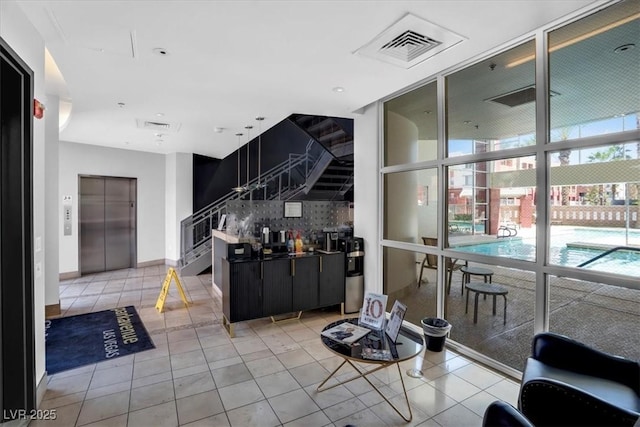 63 E Agate Ave Unit 509, Las Vegas, NV 89123 - living area with elevator, stairway, and light tile patterned floors