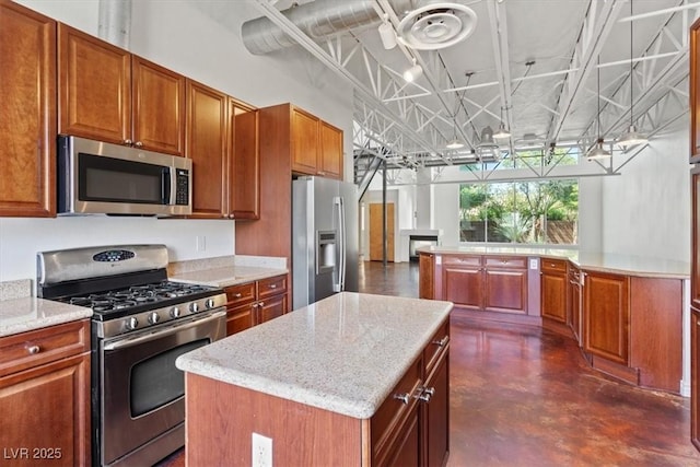 5603 Deer Creek Falls Ct, Las Vegas, NV 89118 - kitchen featuring stainless steel appliances, concrete floors, and brown cabinets