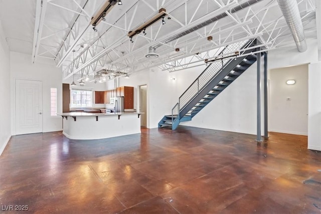 5603 Deer Creek Falls Ct, Las Vegas, NV 89118 - unfurnished living room with finished concrete flooring and stairs
