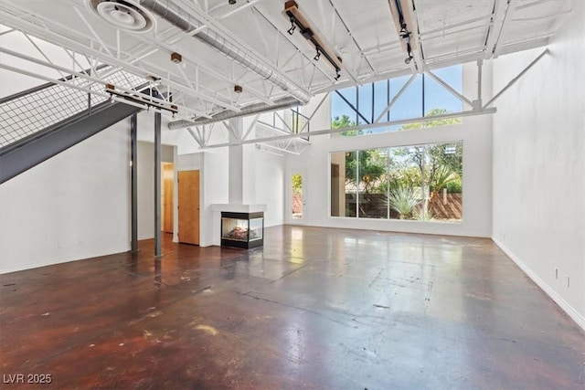 5603 Deer Creek Falls Ct, Las Vegas, NV 89118 - unfurnished living room featuring a high ceiling and concrete floors