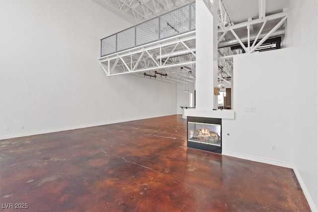 5603 Deer Creek Falls Ct, Las Vegas, NV 89118 - unfurnished living room with concrete flooring and a towering ceiling