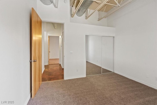 5603 Deer Creek Falls Ct, Las Vegas, NV 89118 - unfurnished bedroom with carpet flooring, a closet, and a towering ceiling